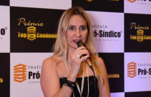 Palestrante com microfone durante uma apresentação.